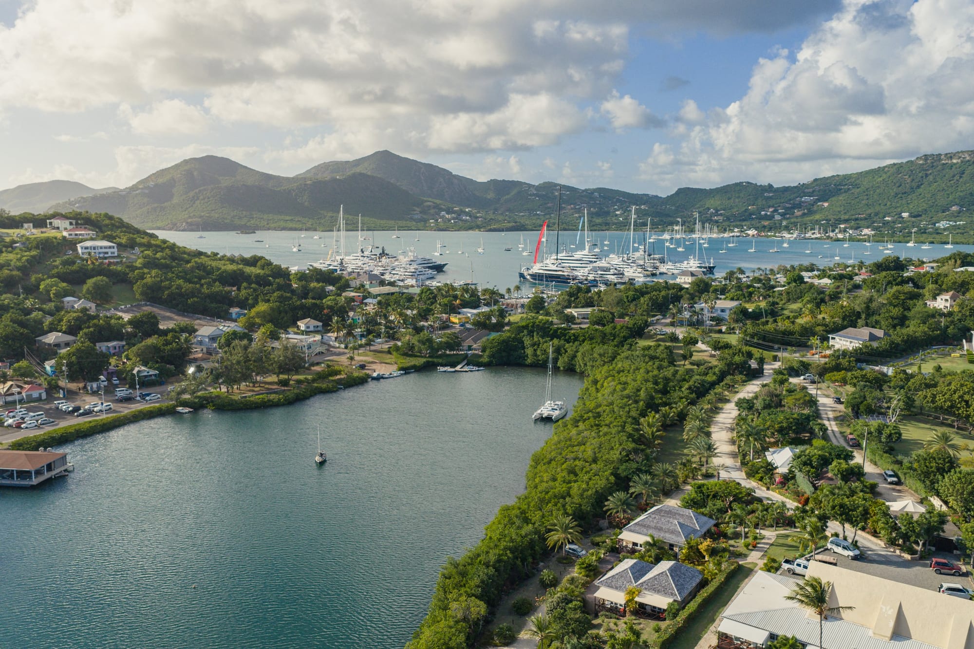 Aerial view over Antigua's green hills towards the harbours