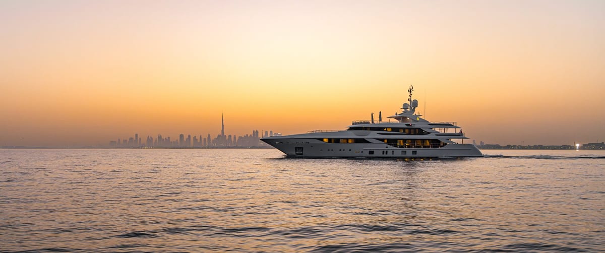 Superyacht cruising on hazy golden water off Dubai