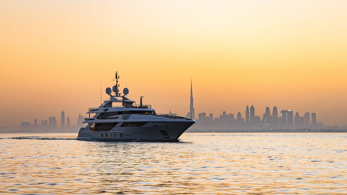 Superyacht on calm water with the Dubai skyline and Burj Khalifa behind