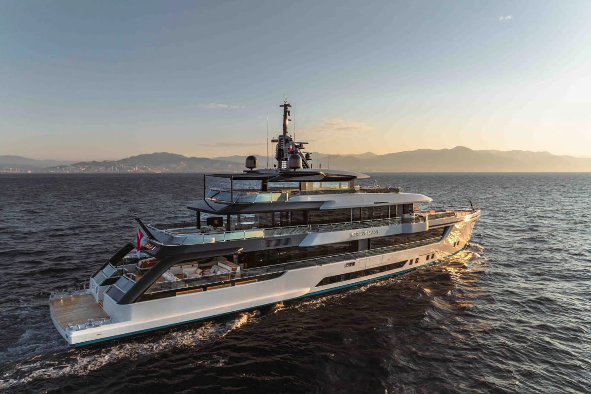 Superyacht underway in low golden light at sunset
