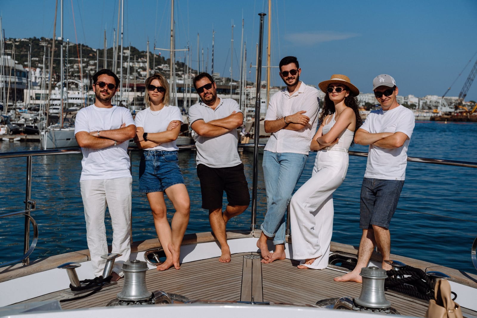The Yacht Media Crew team standing on the bow of a yacht in Cannes harbour