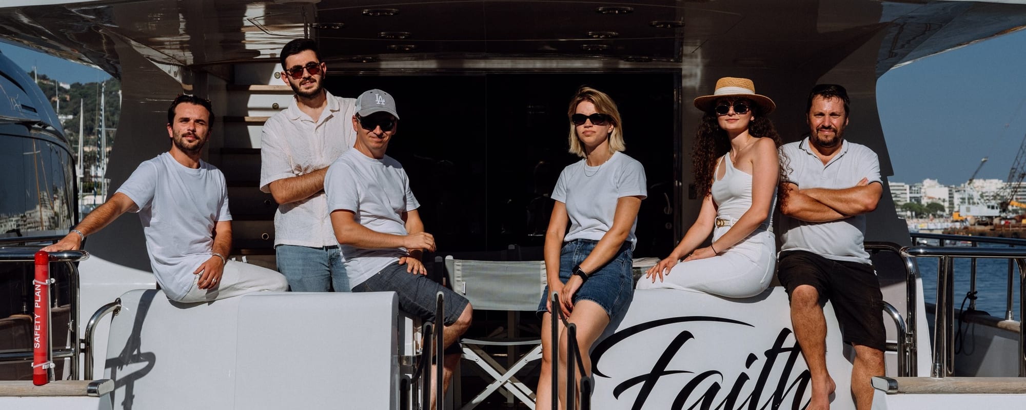 The Yacht Media Crew team on the aft deck of a yacht in Cannes