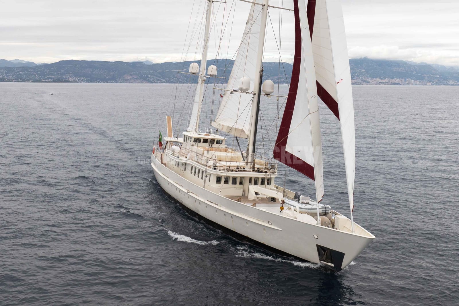 Sailing yacht Dione Star under sail beneath a grey, rainy sky